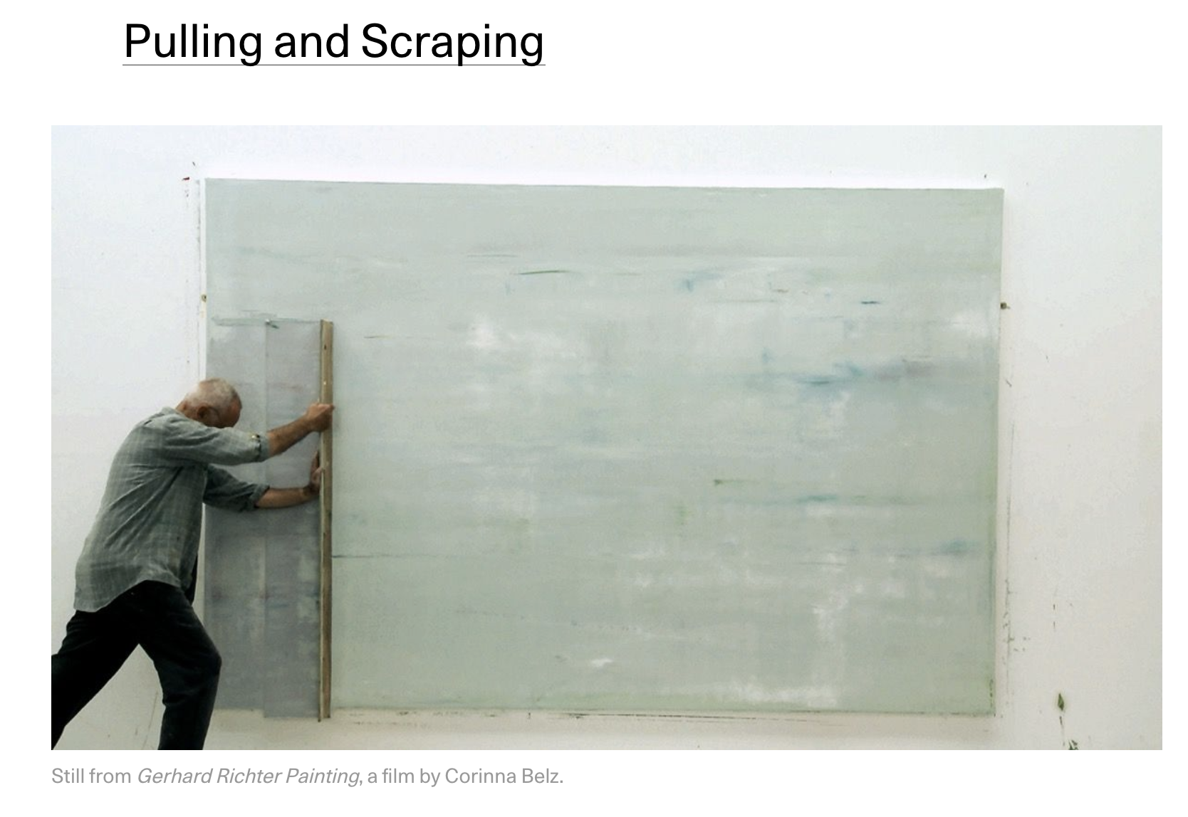 man scraping painting