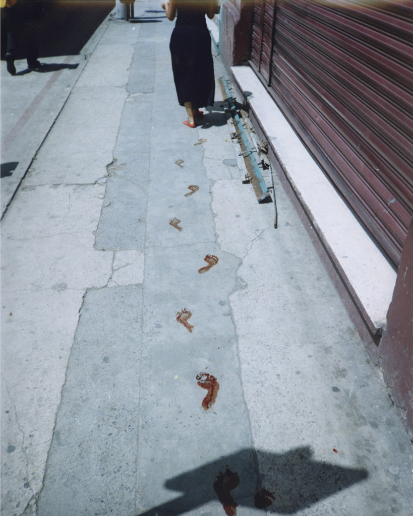woman leaving bloody footprints