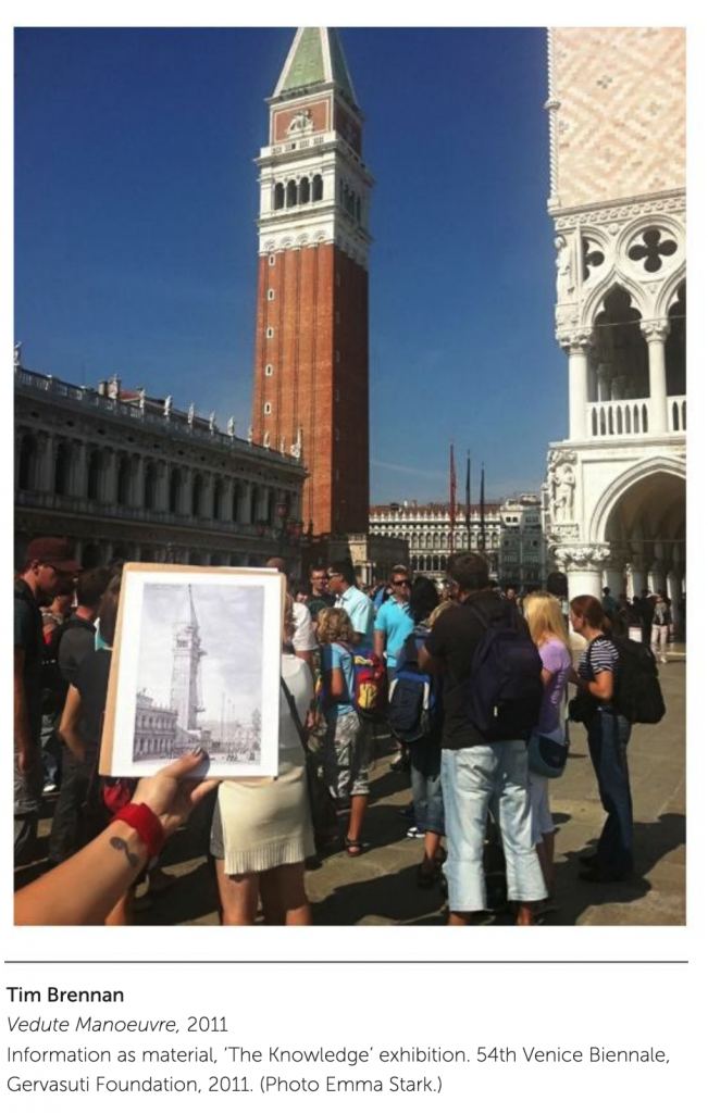 person holding an image of a Venetian tower in front of the tower