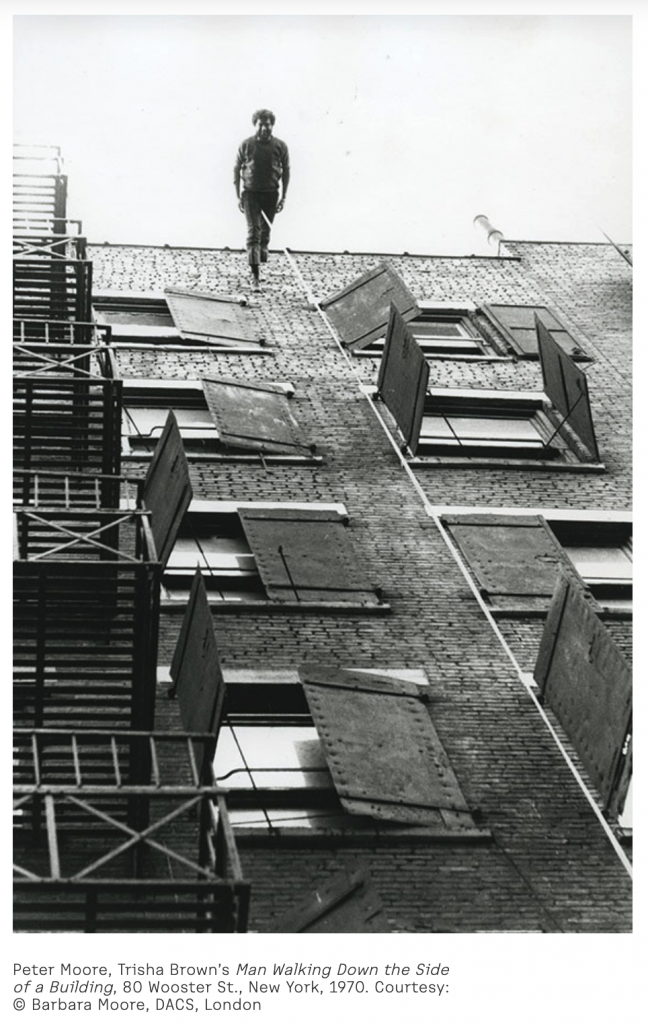 man walking down the side of a building