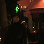 person walking with a pedestrian sign on head
