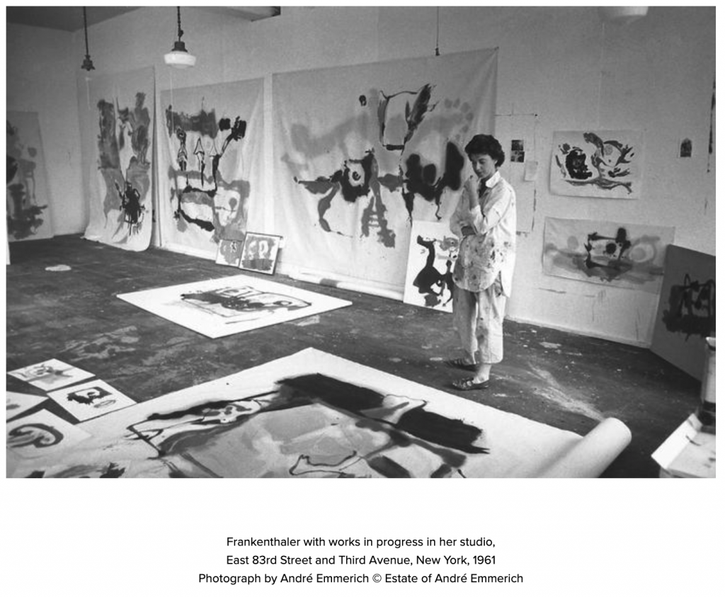 Helen Frankenthaler looking at work on the floor