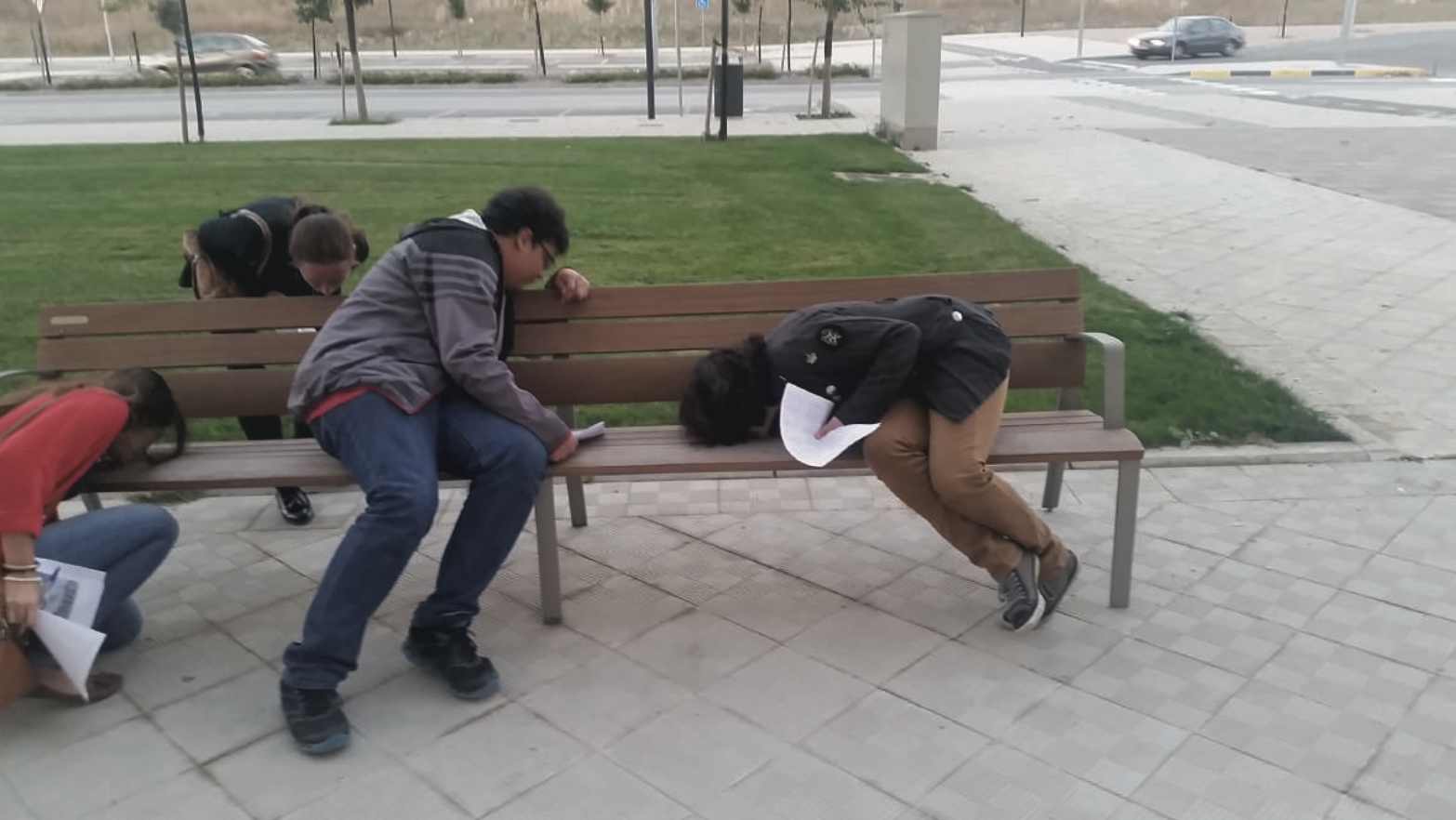 people smelling a bench