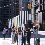 people marching with striped signs