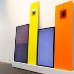 colorful screens leaning against a white wall